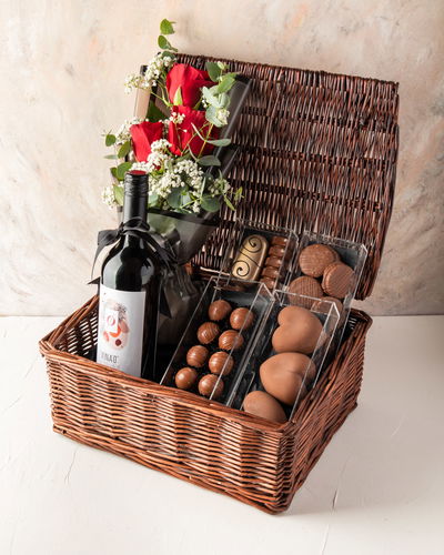 Non Alcoholic Wine, Chocolates and Flower Arranged in Bamboo Basket