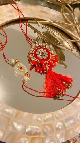 Elegant Red and Pearl Rakhi Set